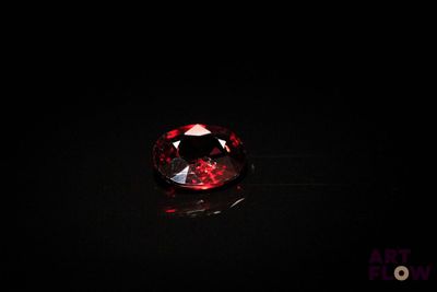 a close up of a red diamond on a black surface