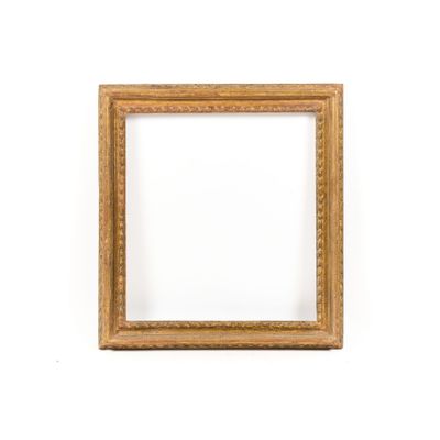 a wooden picture frame on a white wall with a white background