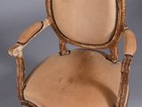 an image of a chair with a beige upholstered seat and a wooden frame