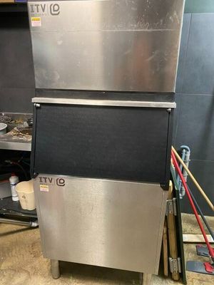 a silver and black ice machine in a kitchen