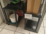 a box and a bucket sitting on a shelf in a room
