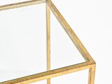 brass coffee table with a glass top and metal frame