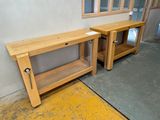 two wooden benches sitting next to each other in a room