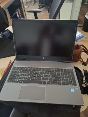 a laptop computer sitting on top of a wooden desk