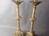pair of antique brass candlesticks with ornate designs