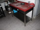 a kitchen with a red table and a black stove