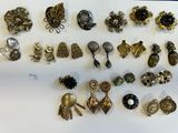 many different types of brooches on a white surface