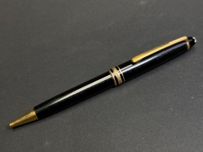un stylo noir et doré posé sur une table
