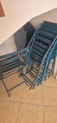 four chairs and a table in the corner of a room