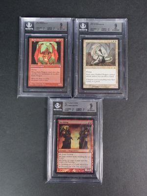 three cards are in a clear plastic case on a black surface