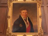 portrait of a man in a blue coat and red tie