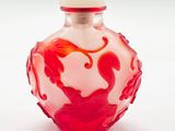 une bouteille en verre ornée d'un motif rouge et blanc