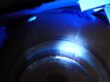 a close up of a metal bowl with a blue light on it