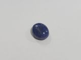 a close up of a blue stone on a white surface
