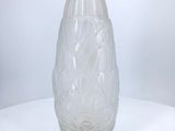 a glass vase sitting on a table with a white background