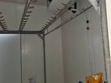 an image of a kitchen with a refrigerator and a rack