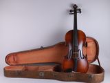 an old violin sits in a case on a white surface