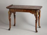 a small wooden table with a marble top on it