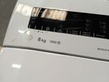 a close up of a white washing machine in a room