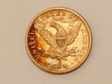 a close up of a coin on a table with a white background