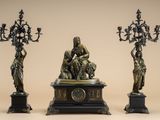 three bronze statues of a woman, a man and a child