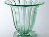 a glass vase that is sitting on a stand