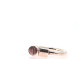 an image of a silver ring with a pink stone in it