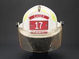 a fireman ' s helmet with a number plate on it