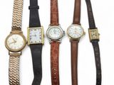 plusieurs types de montres sont alignés sur une surface blanche