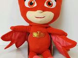 a close up of a red stuffed animal with wings