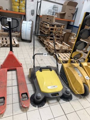 three different types of floor scrubers in a warehouse