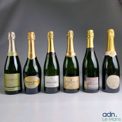 six bottles of champagne lined up in a row on a table