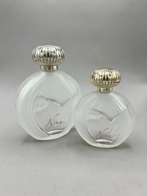 pair of vintage glass perfume bottles with gold trimmings