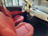 a red leather seat in the front of a small car