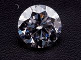 a close up of a diamond on a black surface