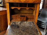 a wooden desk with a marble top in a room