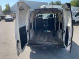 the back of a white van with its doors open in a parking lot