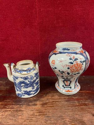 three vases sitting on a table with a red background