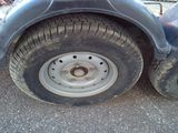 a close up of a flat tire on a trailer