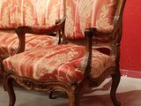 a couch and a chair in a room with a red wall