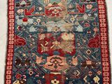 a blue and red rug on a white floor
