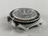 a watch that is sitting on top of a piece of metal