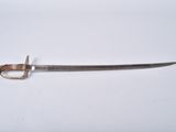 a close up of a sword on a white surface