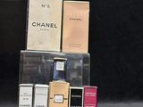 many different perfumes sitting on top of each other