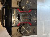 two speakers sitting on top of each other in a room