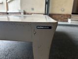 a close up of a white table with a blue sign on it