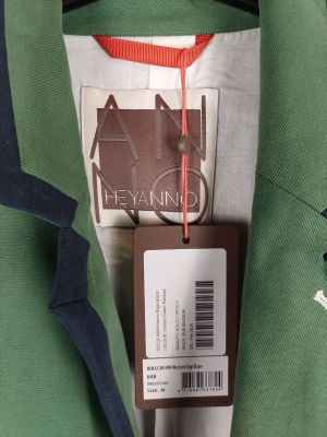 La veste est verte et bleue et comporte une étiquette