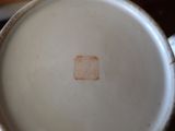 a close up of a coffee cup with a brown spot on it