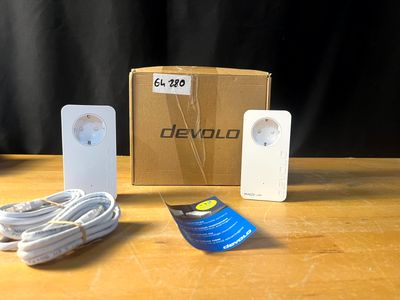 une boîte contenant une télécommande et un chargeur, posée sur une table
