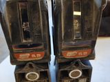 two parking meters sitting on a table in a room